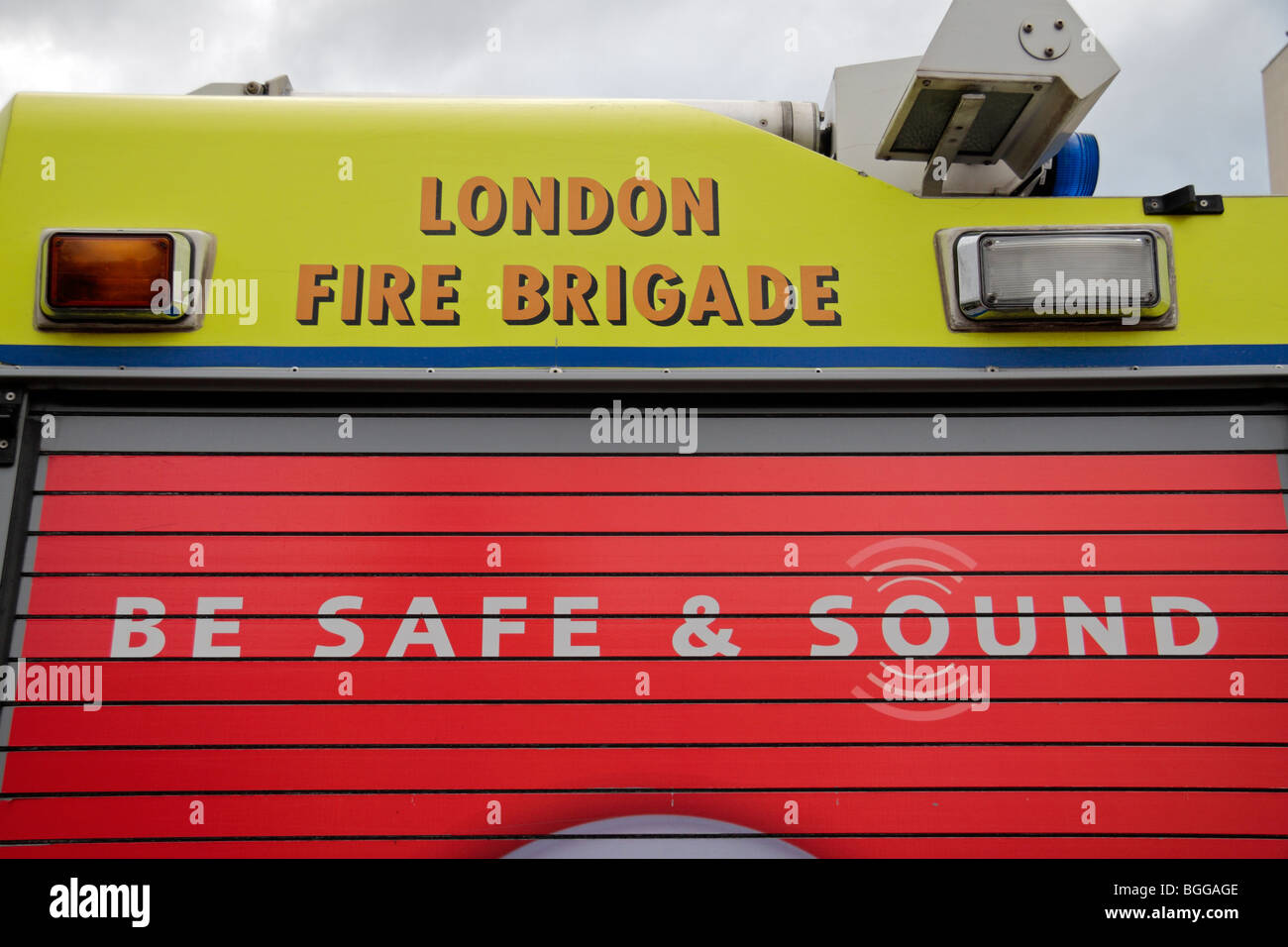 Close up of a roller doored cabinet on the side of a London Fire Brigade with a 'Be Safe & Sound' campaign advert. Stock Photo