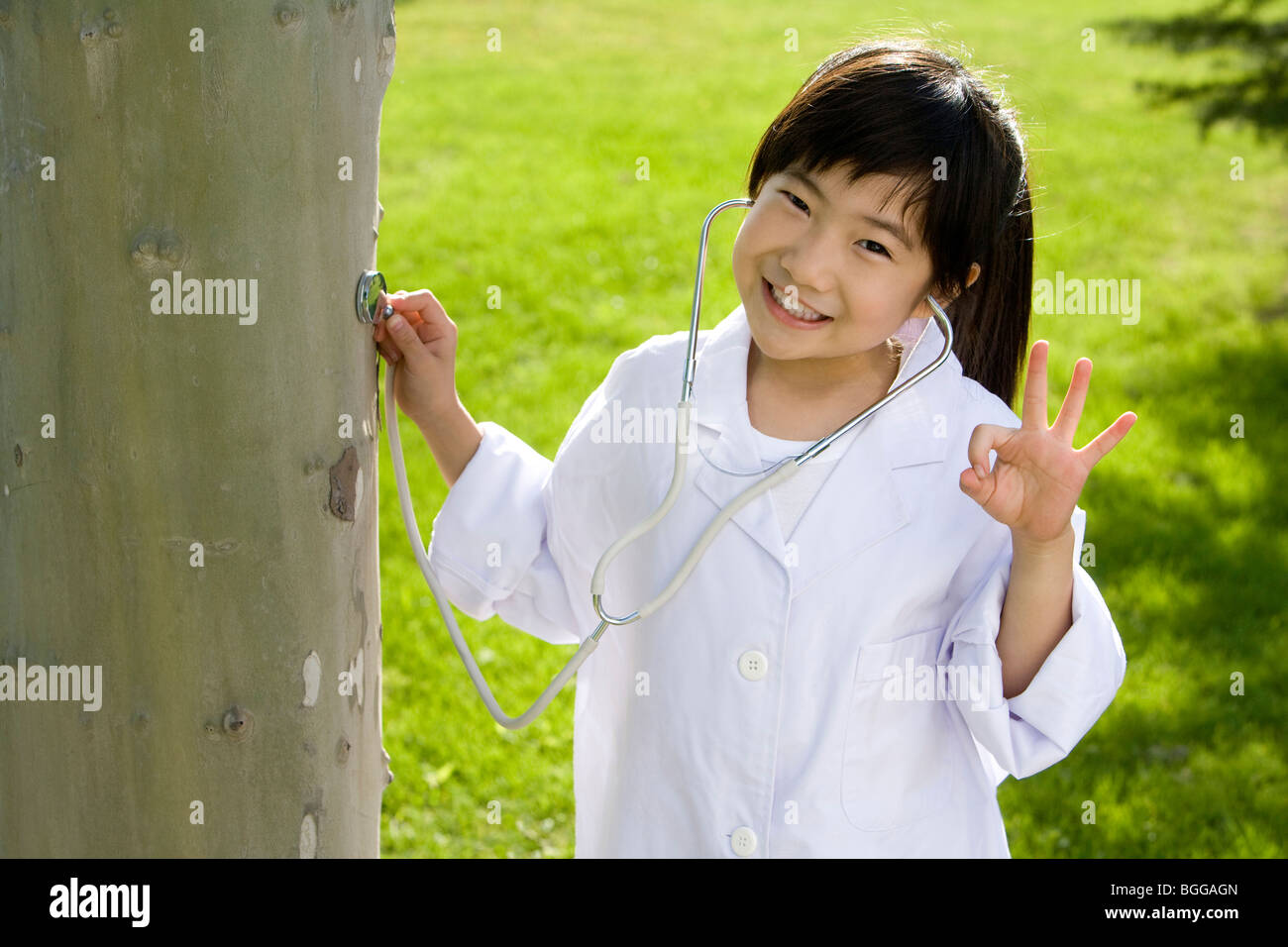 Young girl giving a tree check-up Stock Photo - Alamy