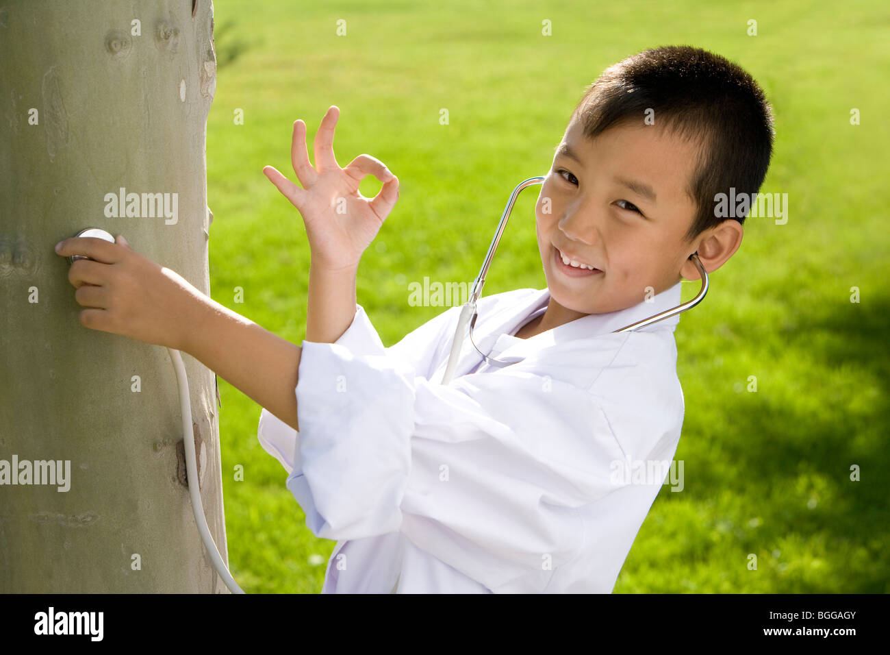 Young boy giving a tree check-up Stock Photo - Alamy