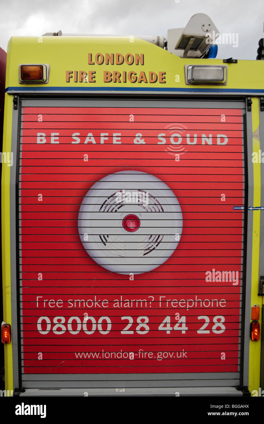 Close up of a roller doored cabinet on the side of a London Fire Brigade with a 'Be Safe & Sound' campaign advert. Stock Photo
