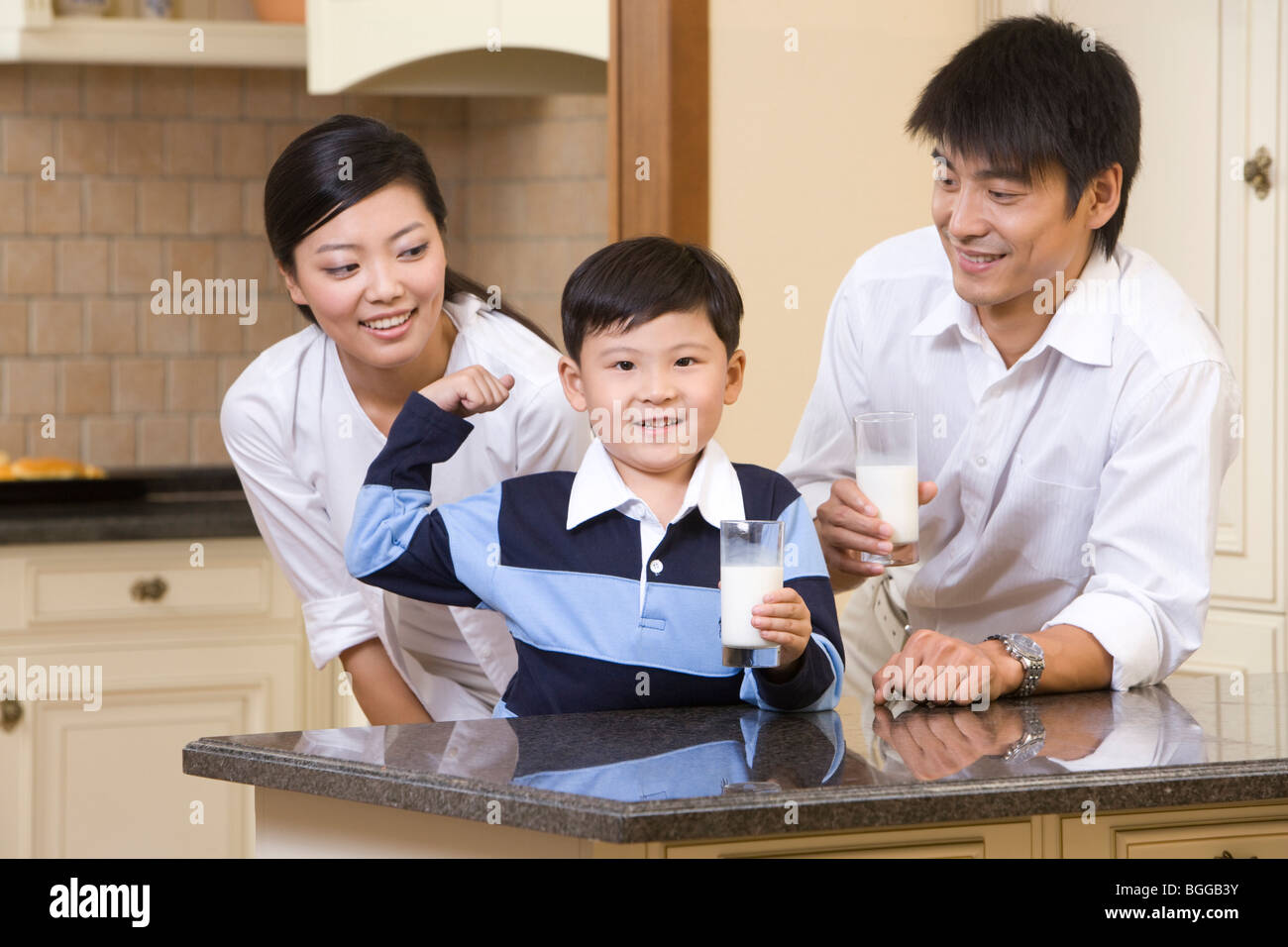 A family of three drinking milk Stock Photo