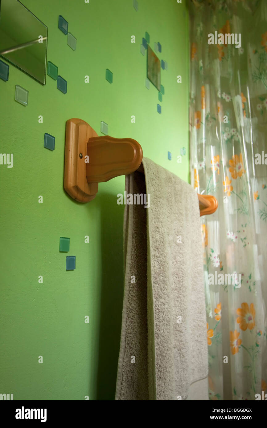Wooden towel-rail in bright green bathroom. color. Stock Photo