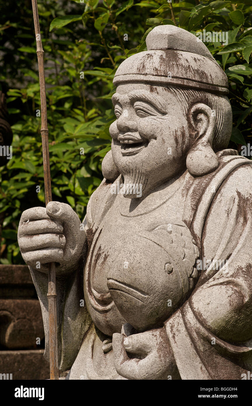 Ebisu, god of fishers or merchants carrying a sea bream. One of the seven lucky Japanese gods. Daikokuten. Kyoto, Japan Stock Photo