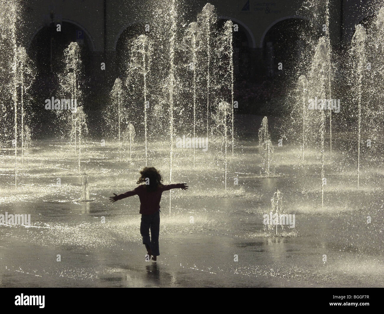 Silhouette of girl playing in fountain Stock Photo - Alamy