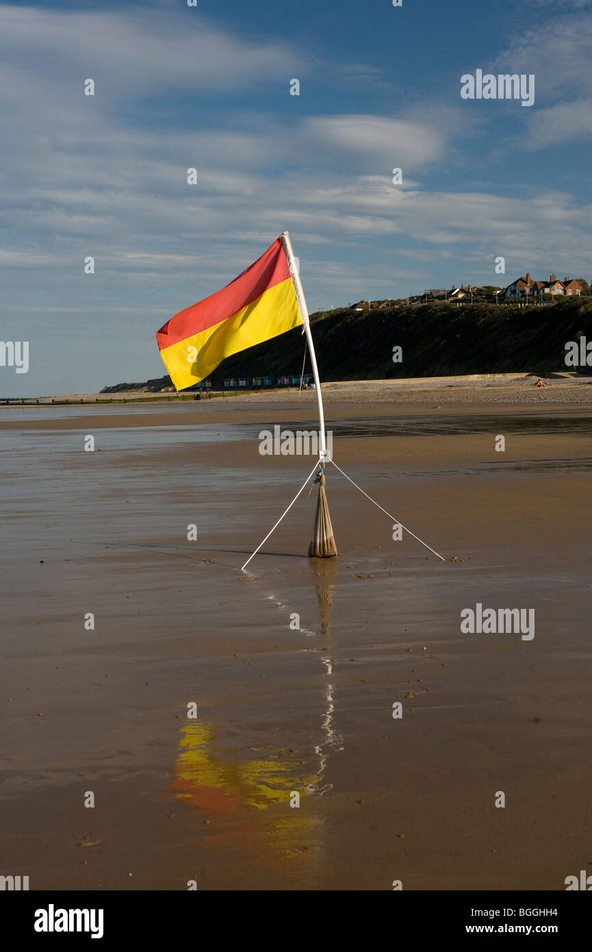 safe to bathe flag flying on deserted wet beach at cromer north norfolk united kingdom Stock