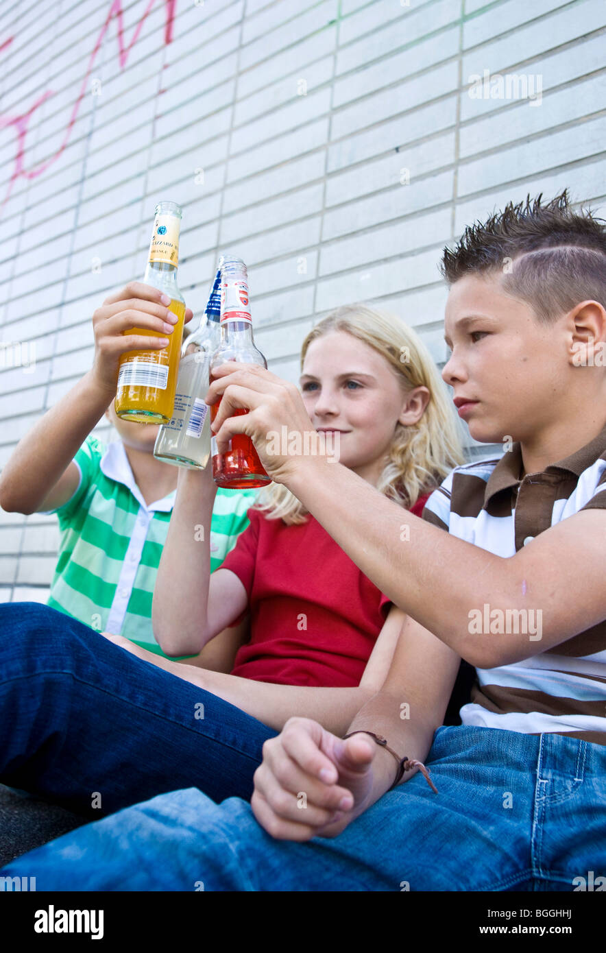 Three children toasting with alcohol, low angle view Stock Photo