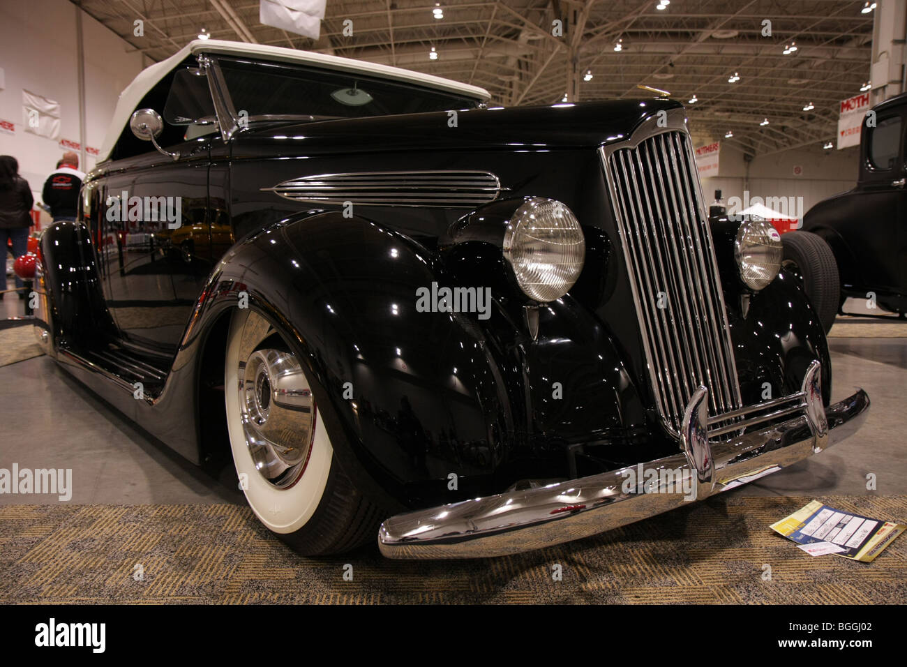 Custom vintage classic luxury black American retro cars on display at a car local indoor car show Stock Photo