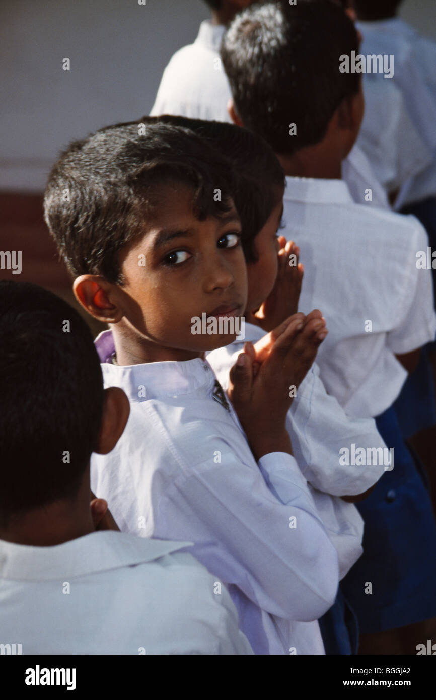 Boy students praying at the Buddhist school, Polonnaruwa, Sri Lanka Stock Photo