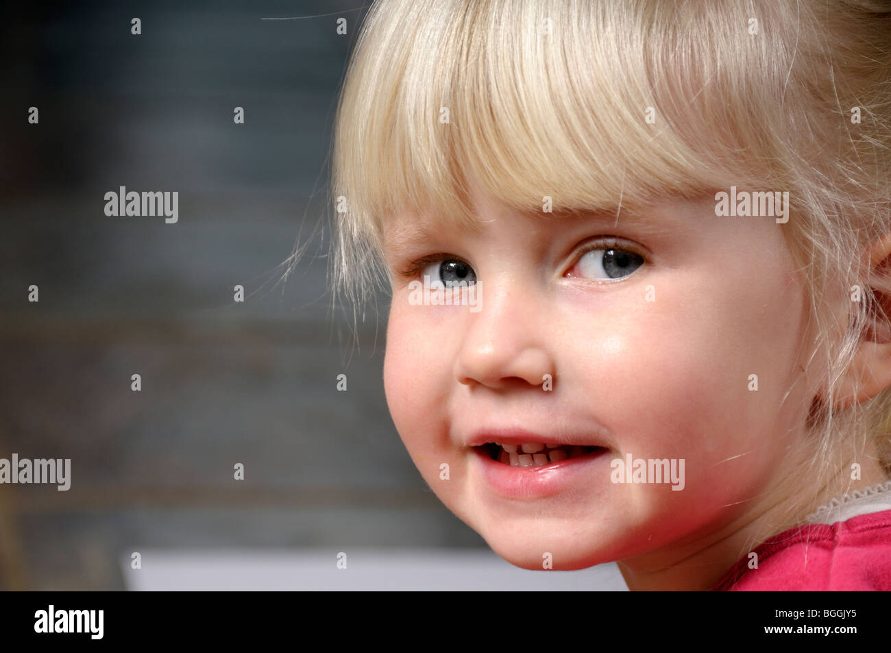 Stock Photo Of A 3 Year Old Blond Haired Girl Smiling At The Camera