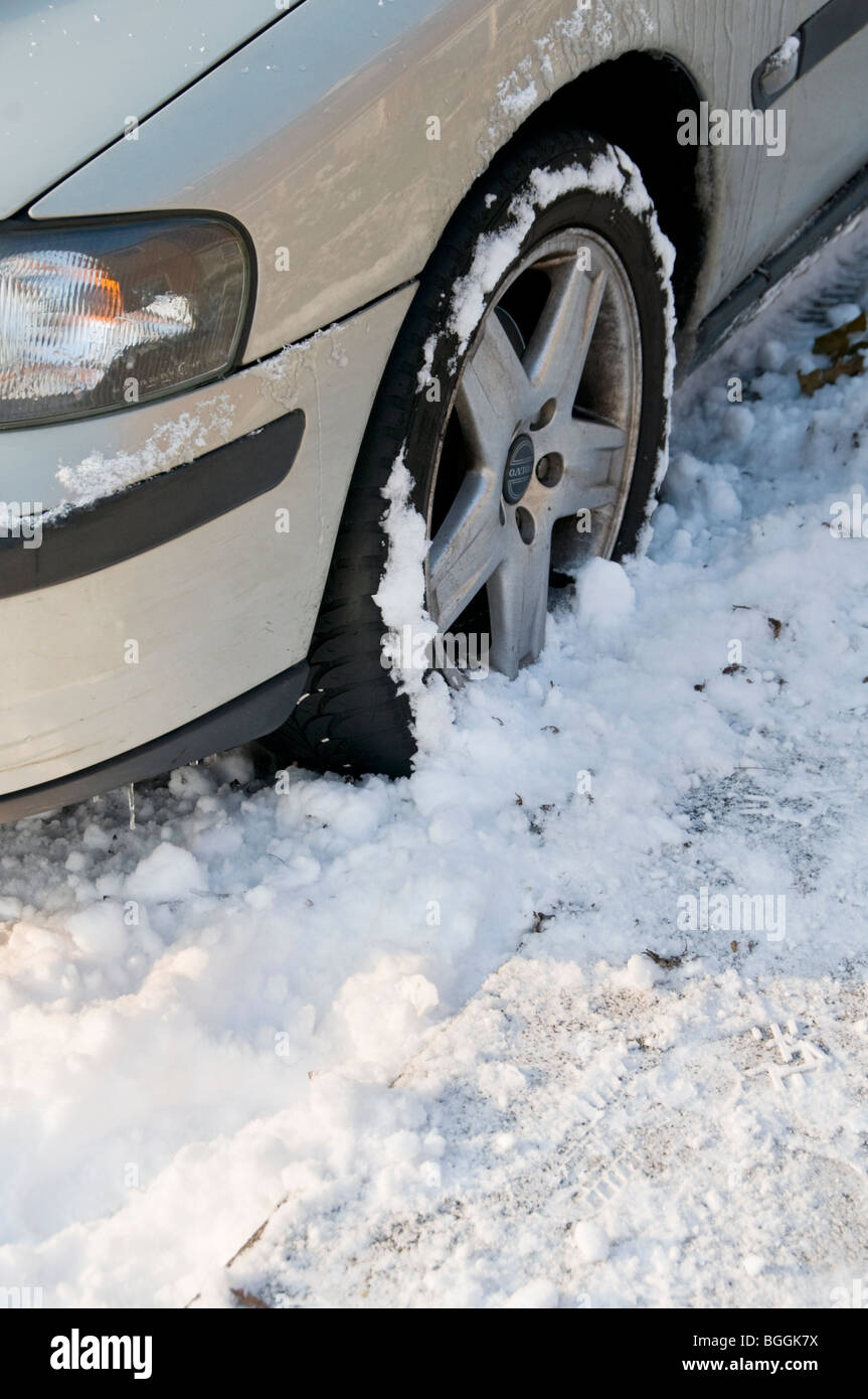 Detail of a car parked on a snowy road Stock Photo