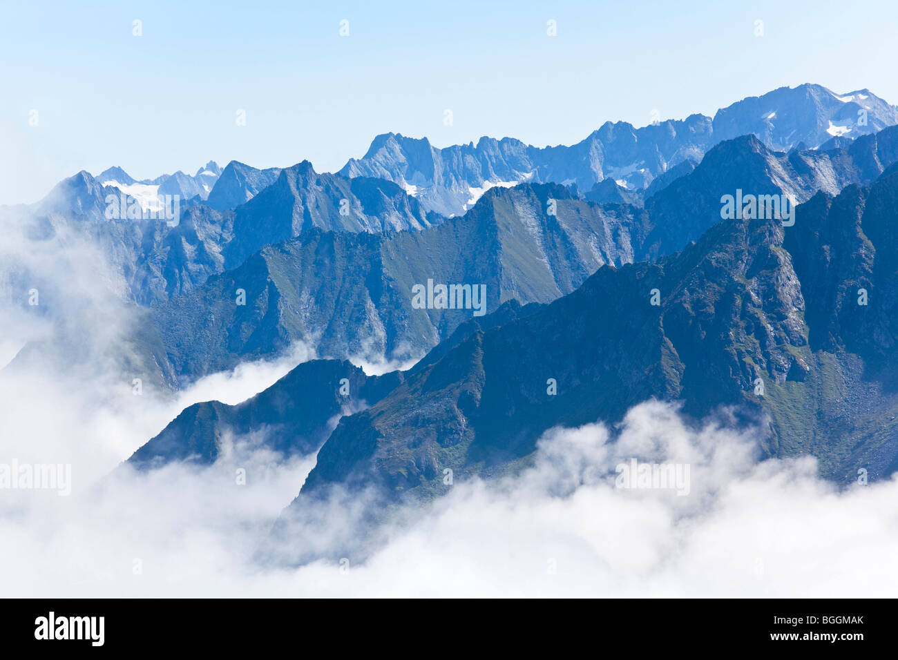 Mountain ridges of the Zillertal Alps surrounded by clouds, Tyrol, Austria, high angle view Stock Photo