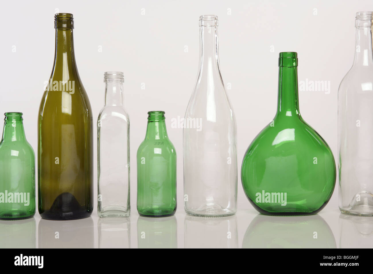 Green and Clear bottles against a white background Stock Photo - Alamy