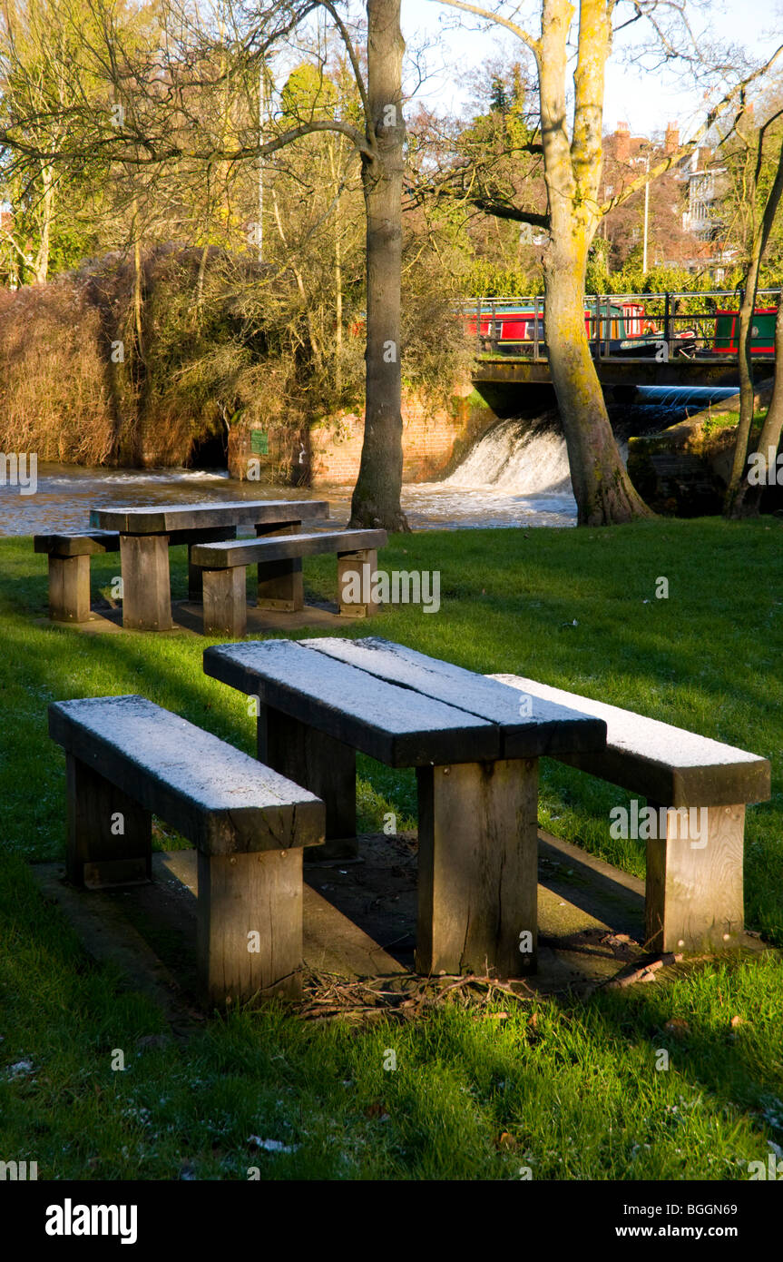 Frost on picnic tables by the weir Stock Photo