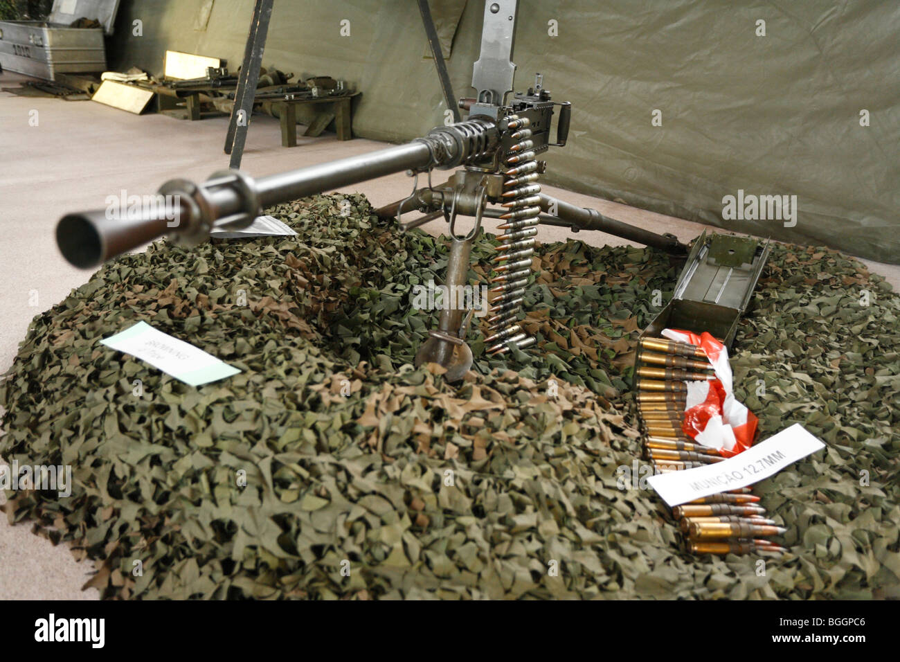 Portuguese Army Browning M2HB heavy machine gun, mounted on a tripod, and some ammunitions. Stock Photo