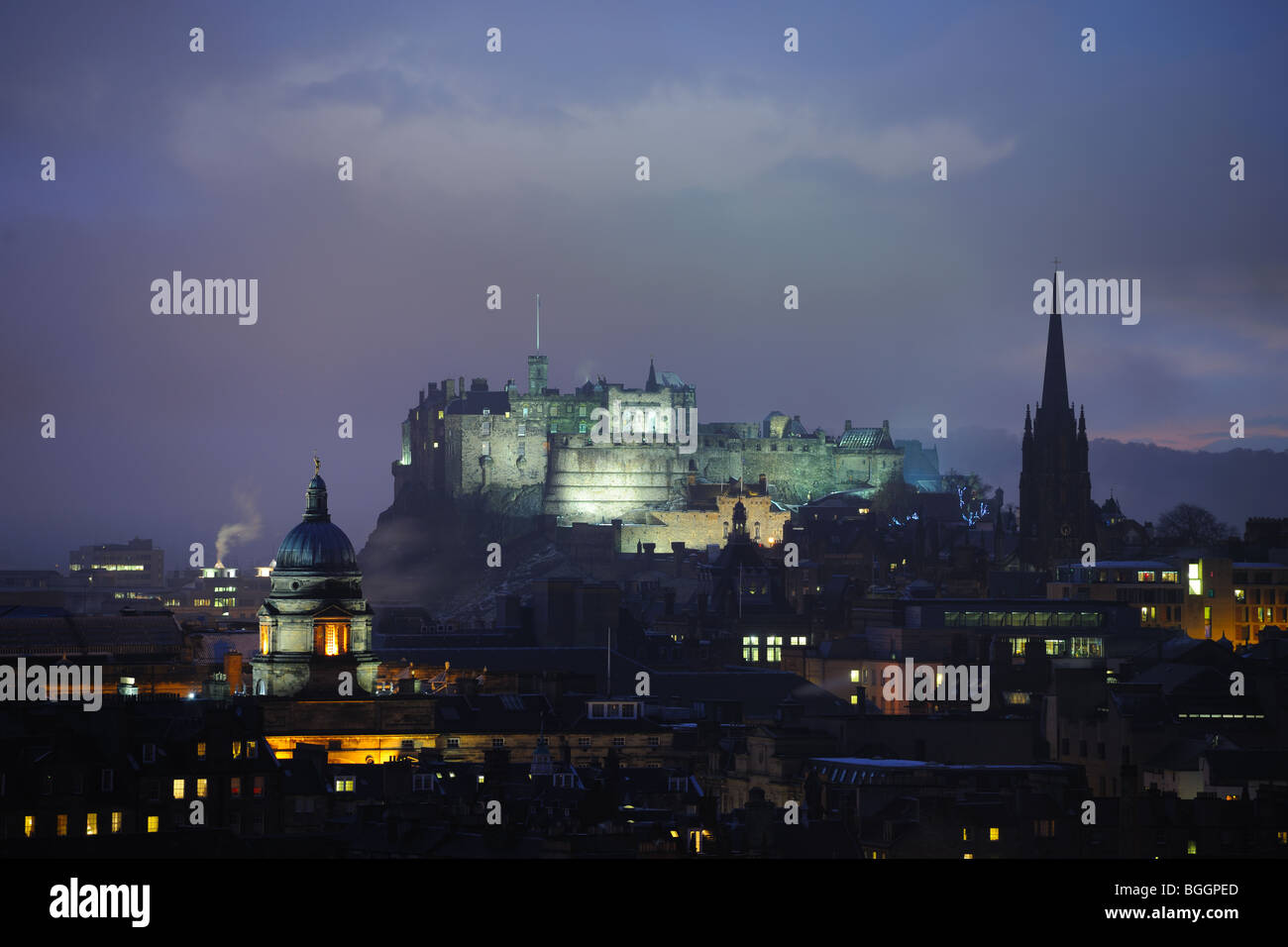 Edinburgh Castle, Scotland, at dusk in winter. On the left is the dome of the Talbot Rice Gallery, on the right the Hub. Stock Photo
