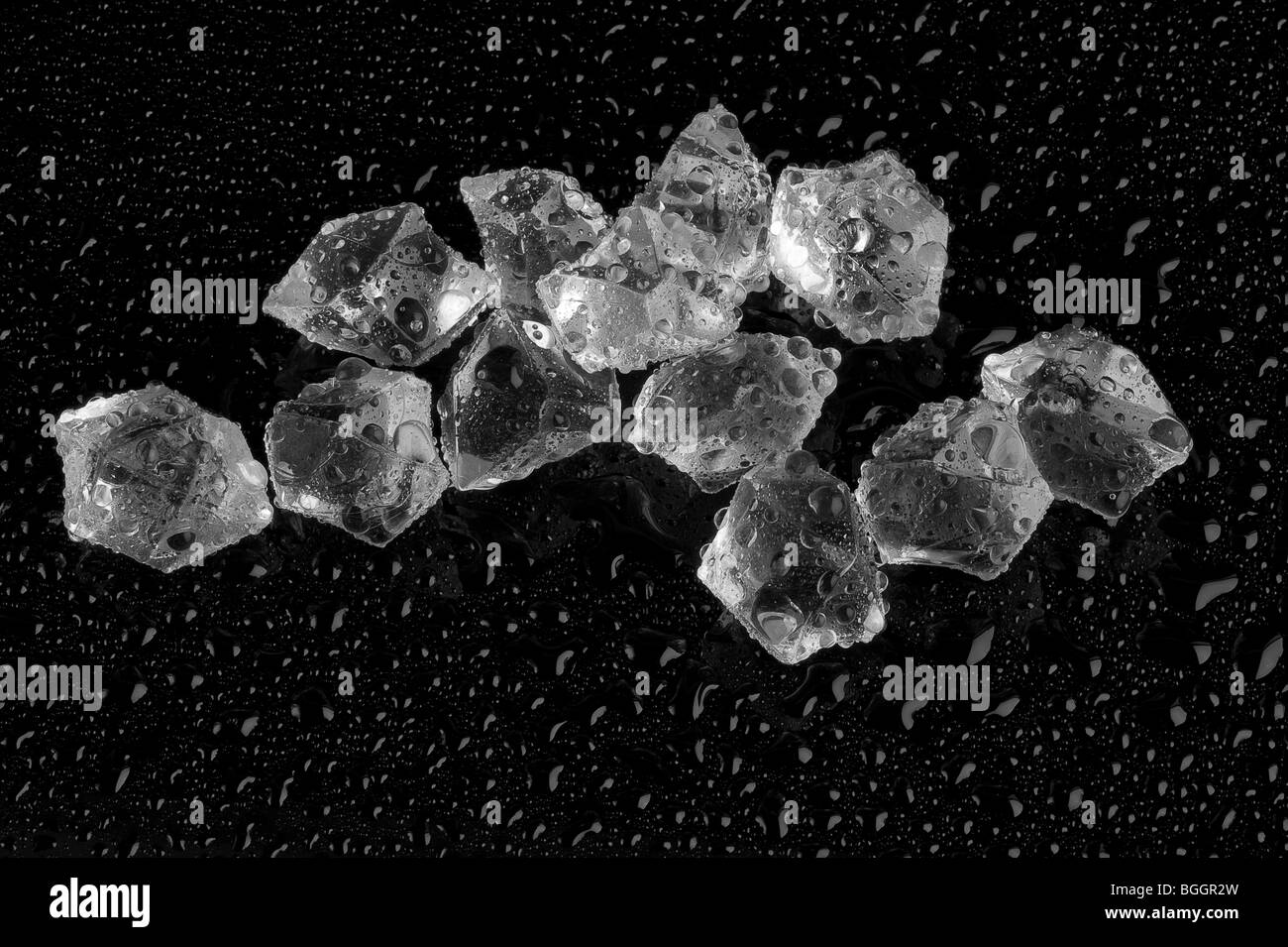 ice cubes on a wet black background Stock Photo - Alamy