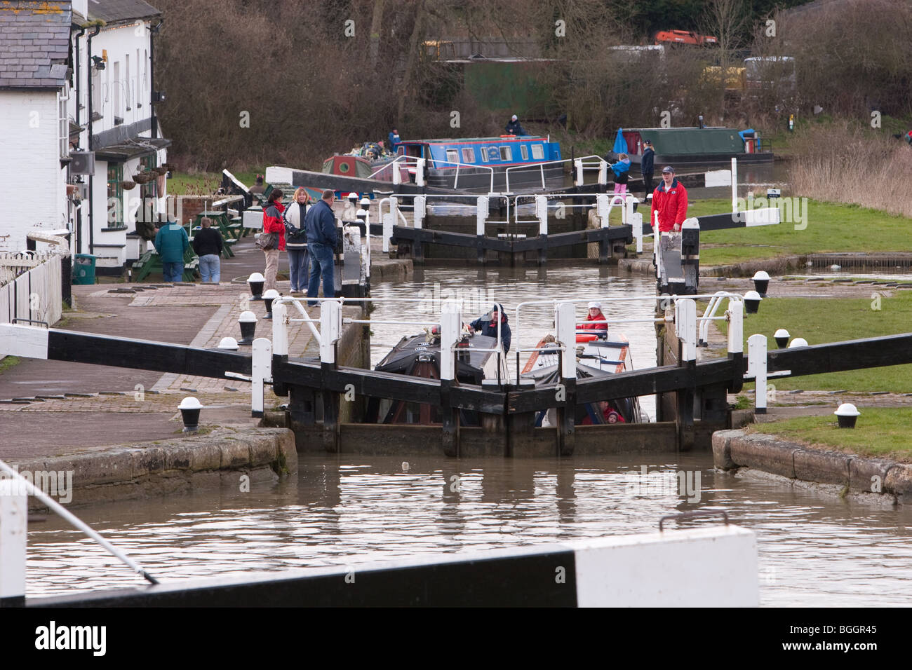 Two canal boats passing through one of three locks at Soulbury in Buckinghamshire UK Stock Photo