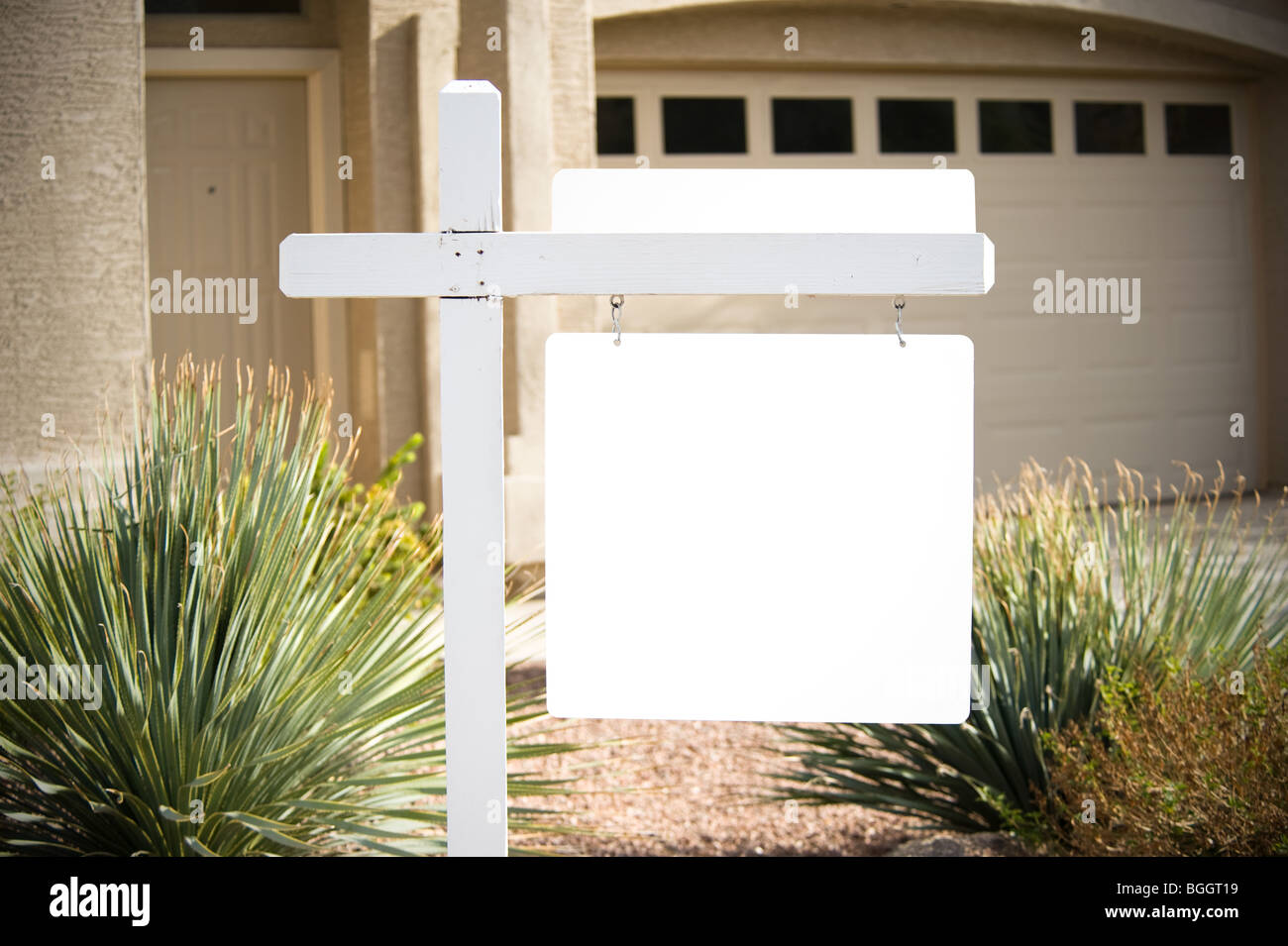 A home for sale has a for sale sign that is blank for copy space. Stock Photo