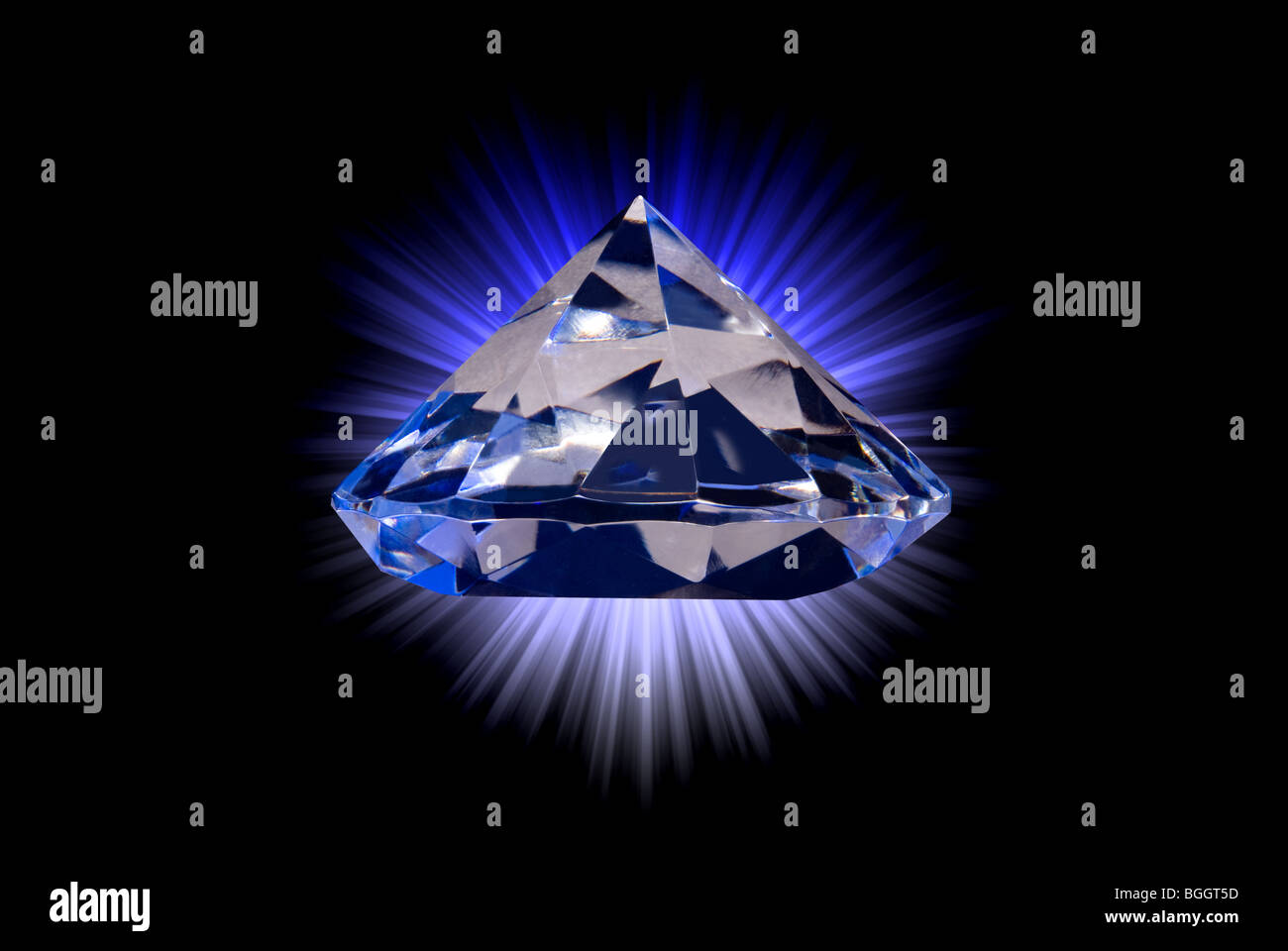 A diamond gem against a star burst gradient background. Stock Photo