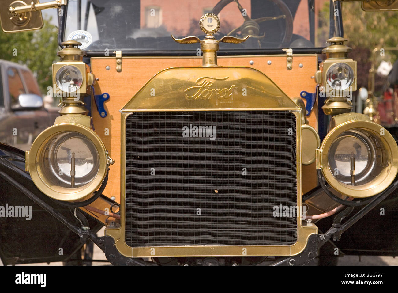 Closeup of front of antique Ford car at rally of horseless carriages