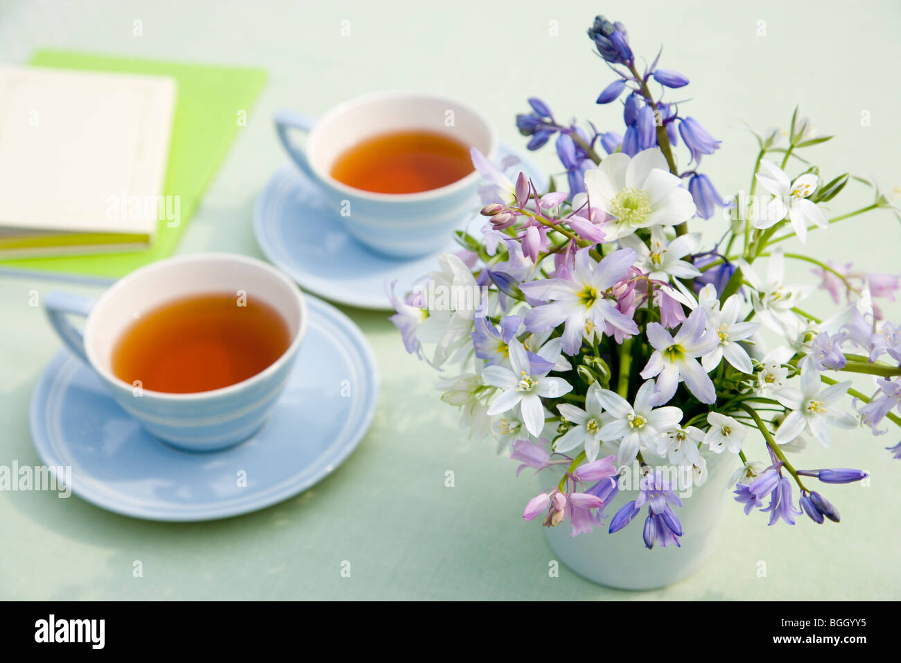 Cups of tea and a vase of flowers Stock Photo