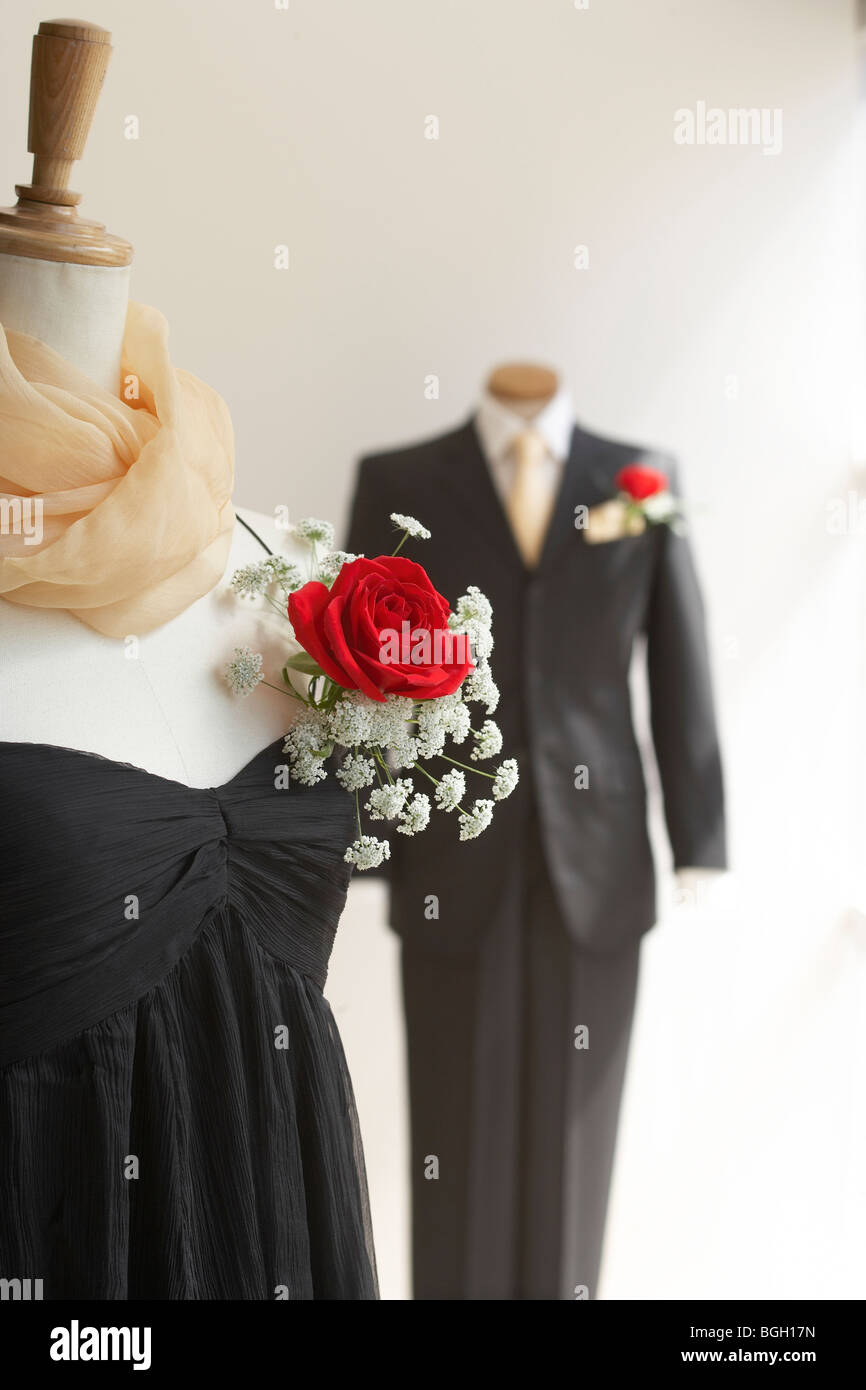 Black dress and tuxedo with corsage white background Stock Photo - Alamy
