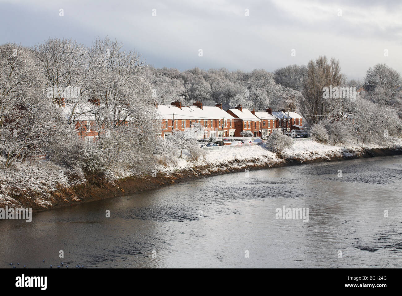 A terrace of houses at Fatfield adjacent to the river Wear in snowy conditions Stock Photo
