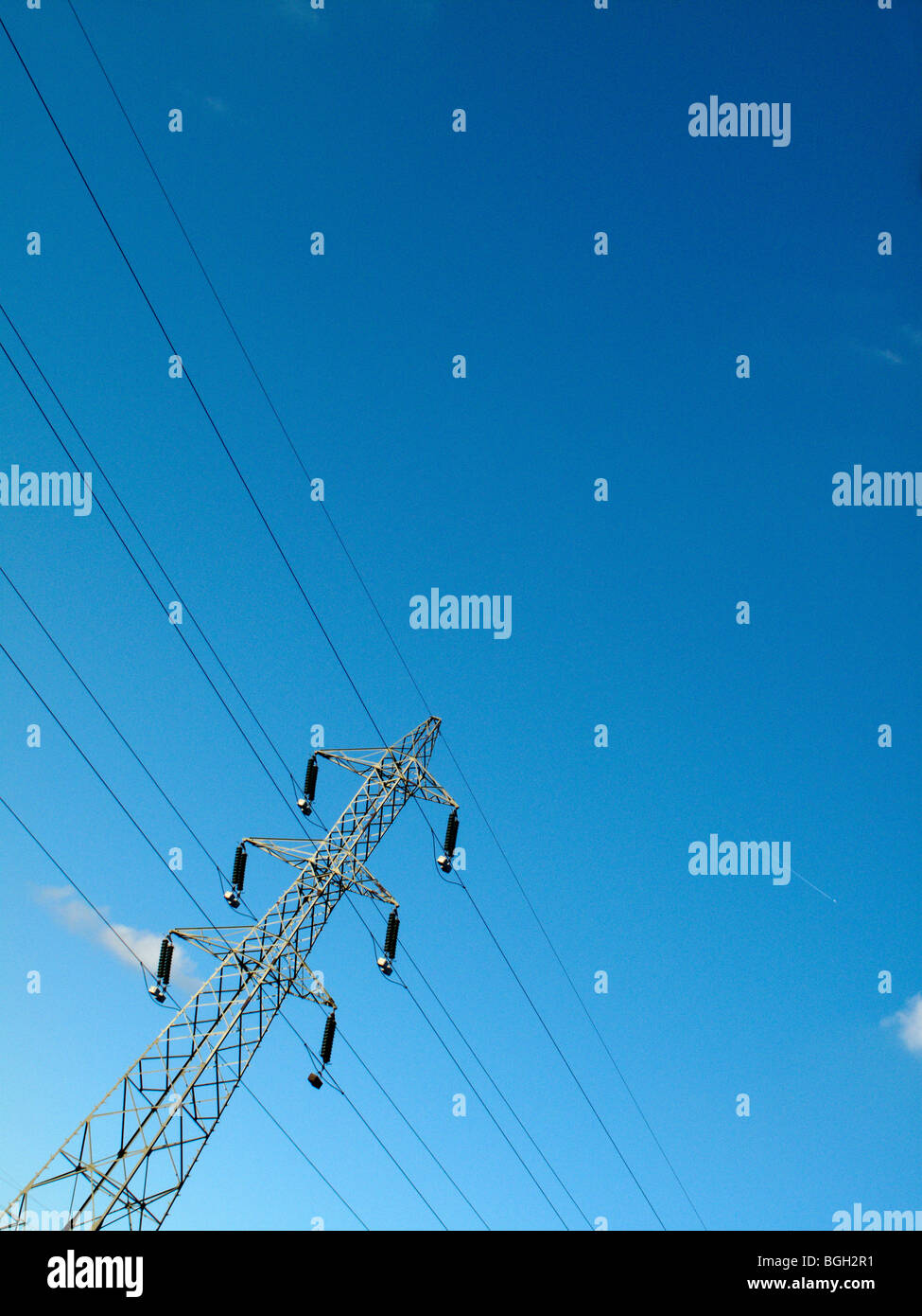 Electricity pylon against a blue sky Stock Photo - Alamy