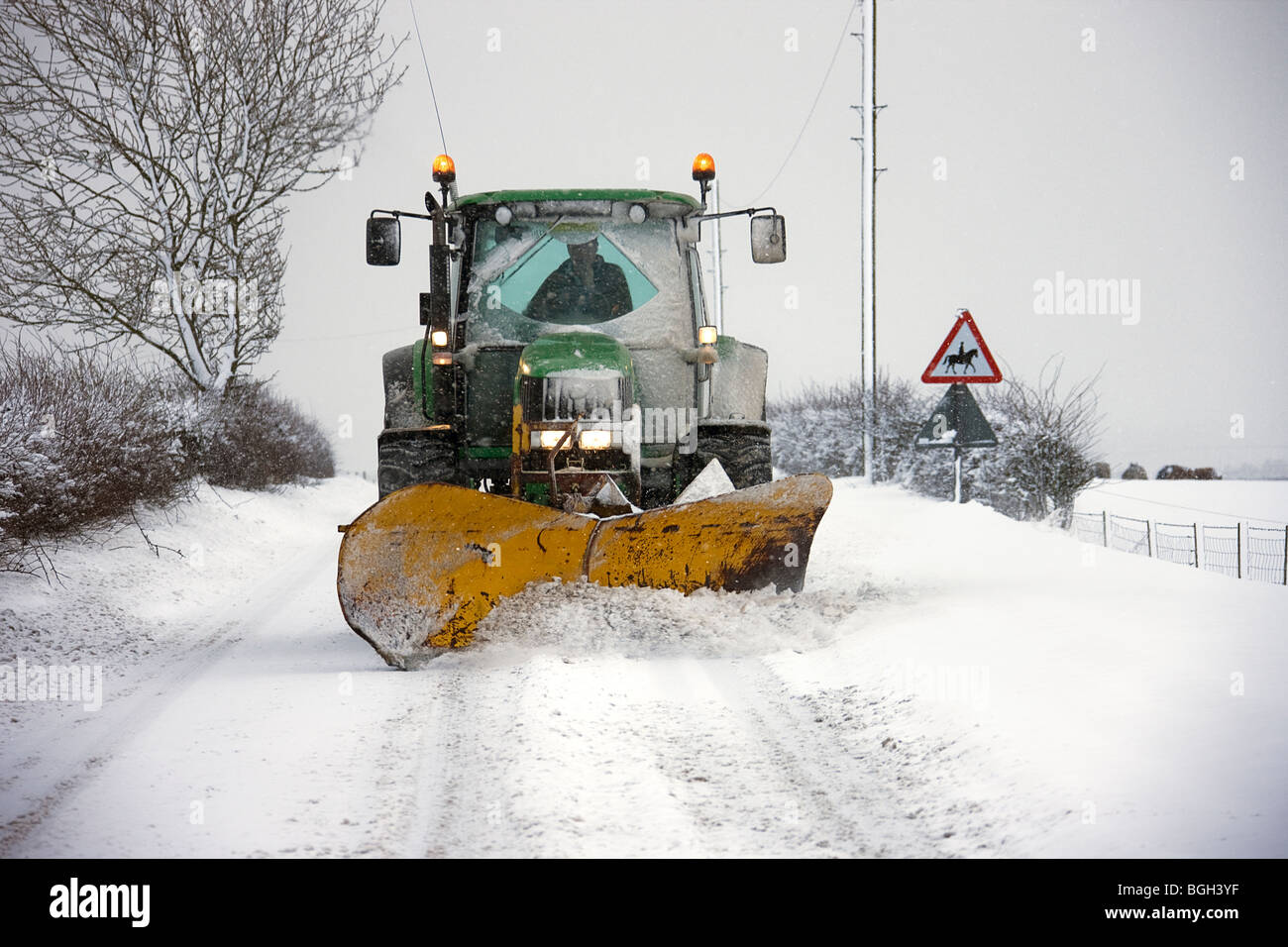 Snow plough working on back roads. Northumberland Stock Photo Alamy