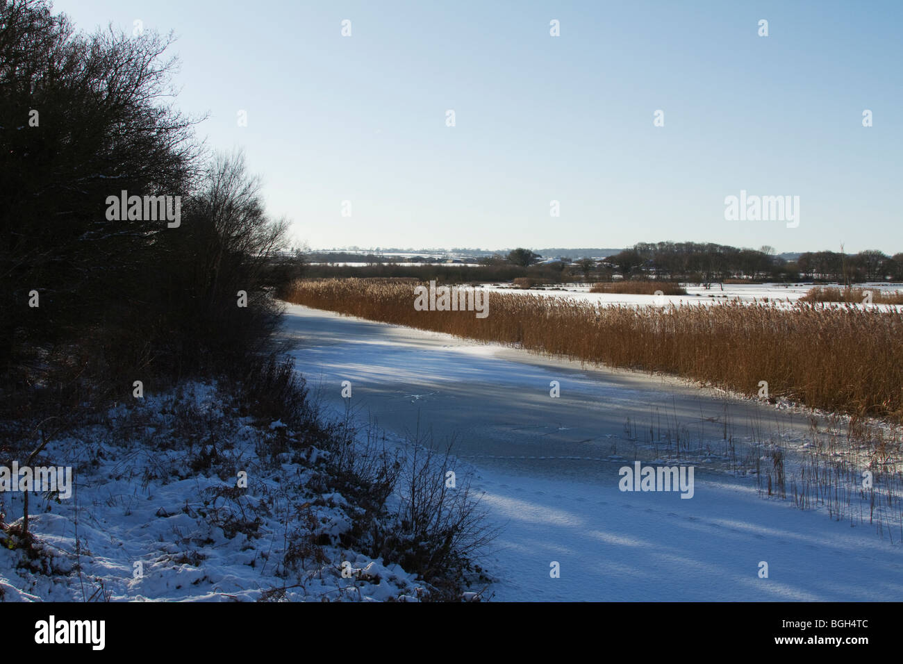 The channel near the hide on Noah's Lake at Shapwick Heath following heavy snow and freezing conditions. Stock Photo