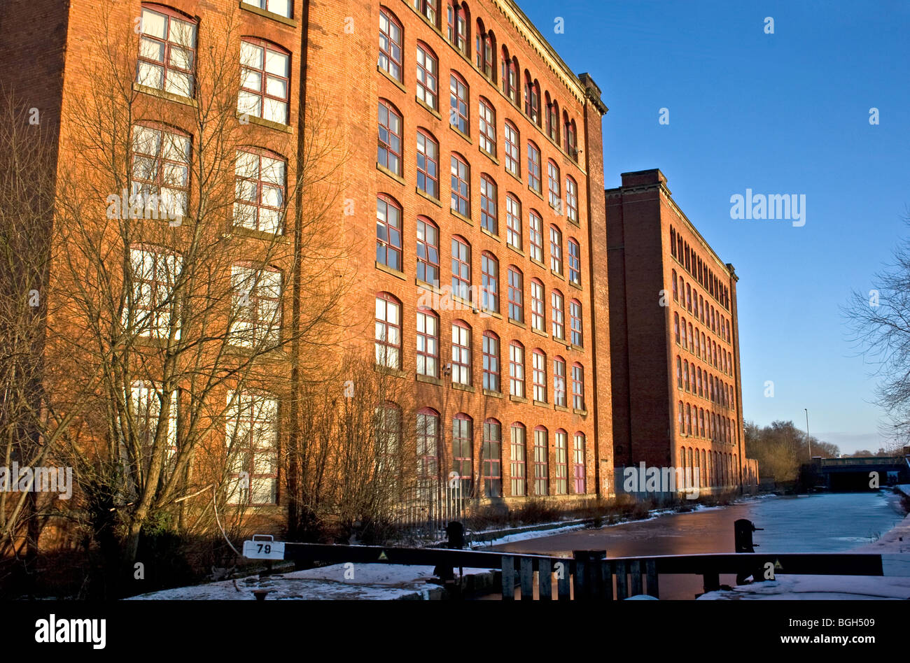 Victoria Mills (1867  + 1873) and Rochdale Canal, Miles Platting, Manchester, UK. Now residential, business and educational use. Stock Photo