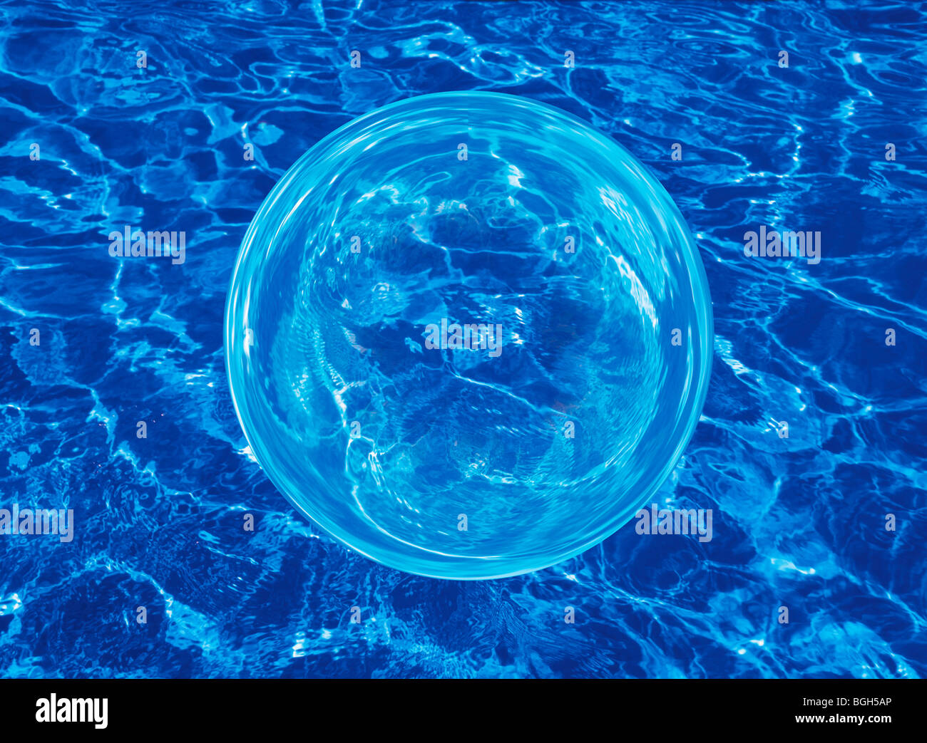 Sphere floating over rippling water Stock Photo Alamy