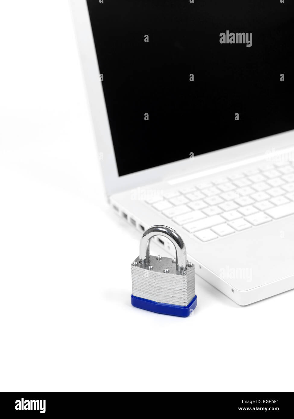 A laptop computer and a padlock isolated against a white background ...