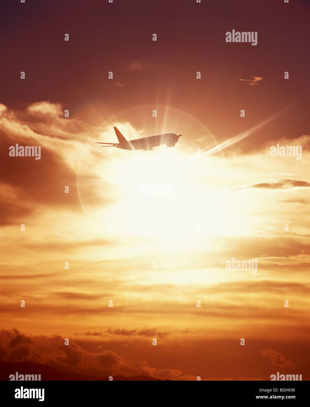 Airplane flying at sunset Stock Photo - Alamy