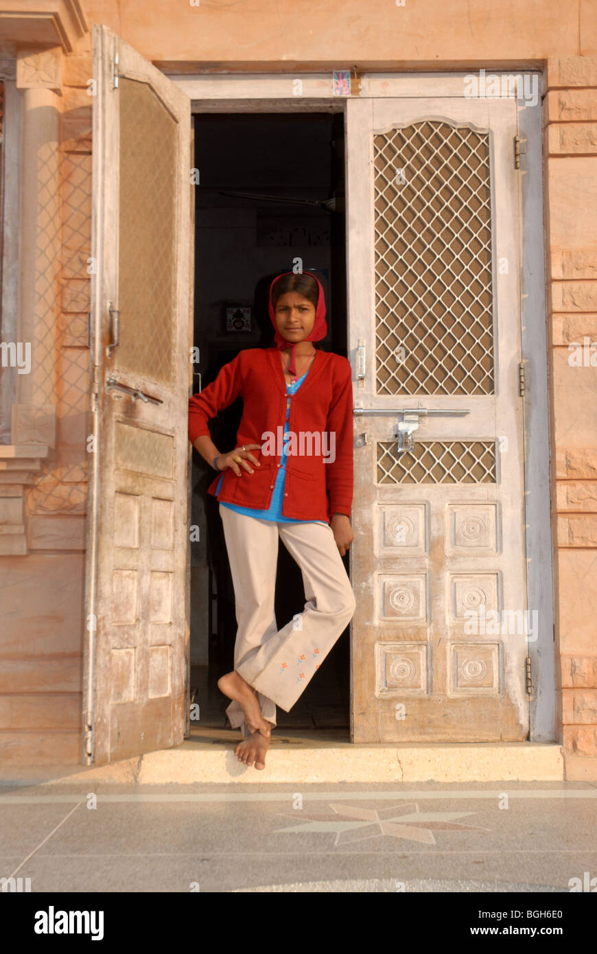 Rajasthani young woman standing in doorway looking at camera Stock ...