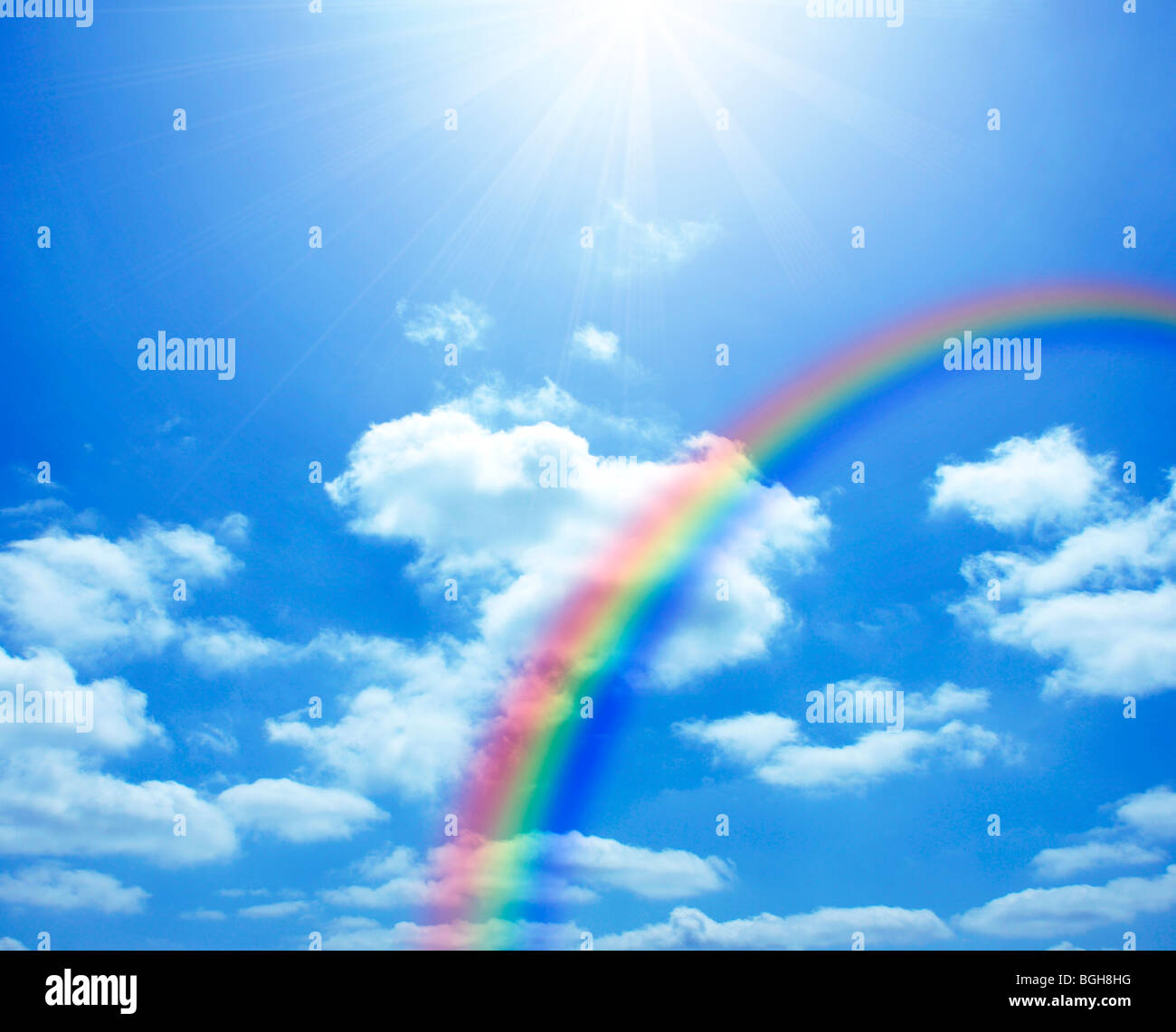 Rainbow and clouds in a sunny blue sky Stock Photo - Alamy