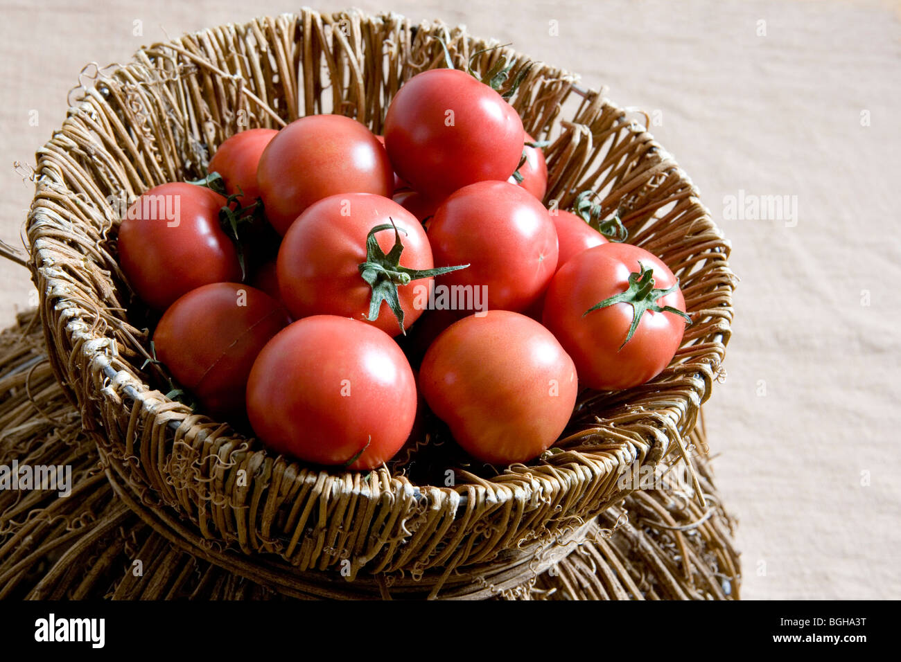 Tomatoes in a bamboo basket Stock Photo Alamy