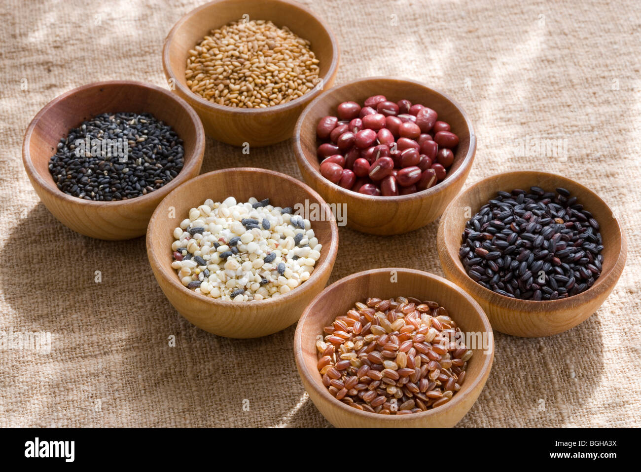 Wooden bowls of different grains and beans Stock Photo
