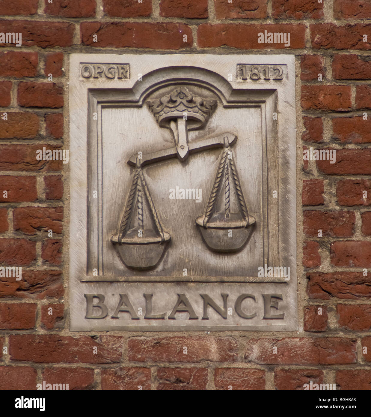 Balance mural on red brick wall Stock Photo