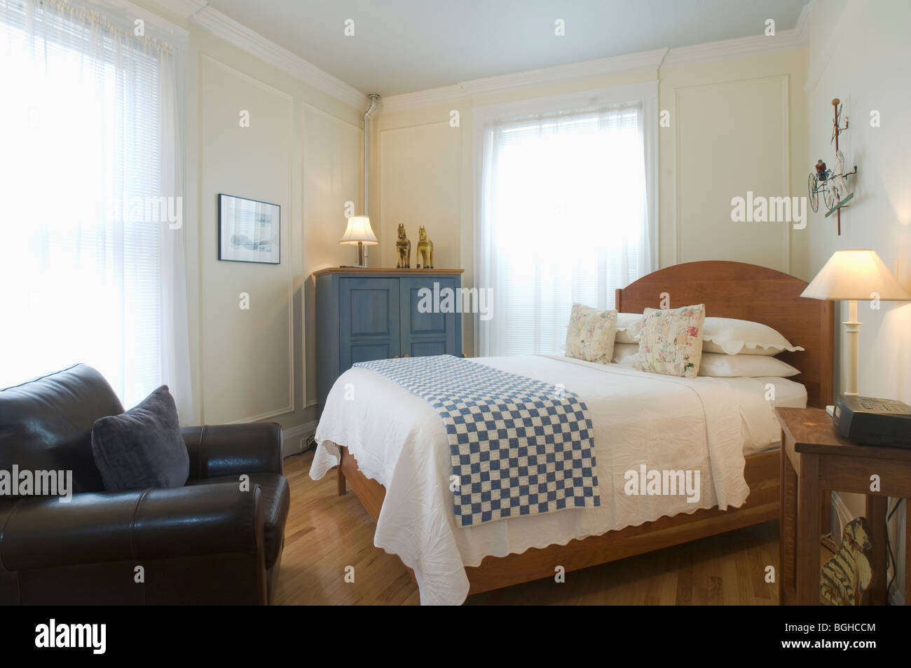 Bed and armchair in small studio apartment Stock Photo Alamy