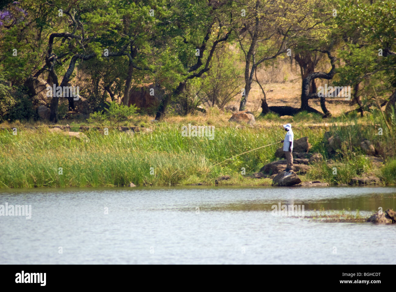 A man fishing for food at Hillside Dams in Bulawayo, Zimbabwe. Stock Photo