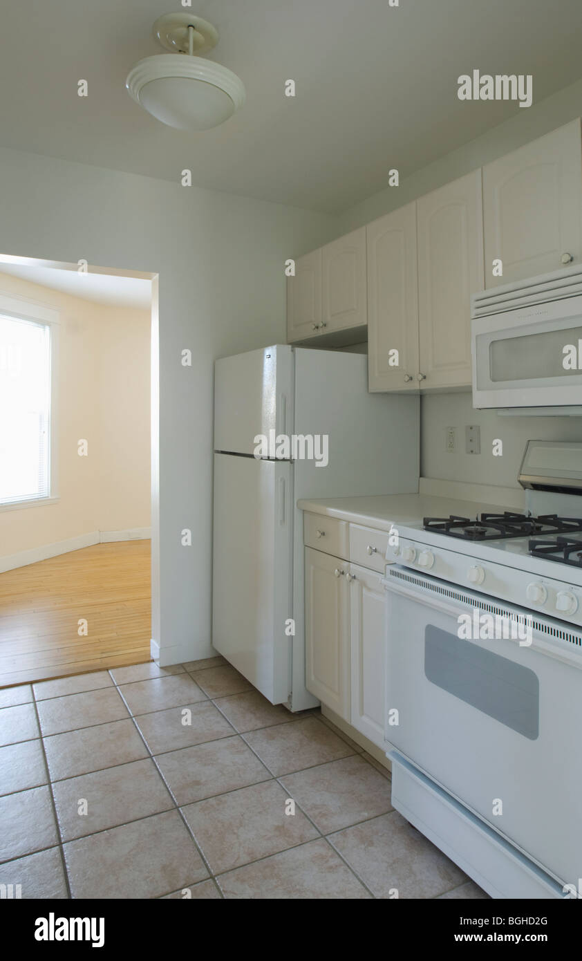 White stove and kitchen in empty apartment Stock Photo