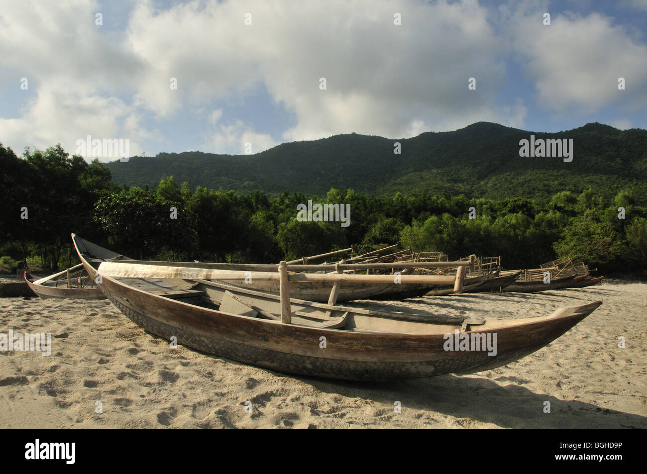 Wooden fishing canoes on a topical beach Stock Photo