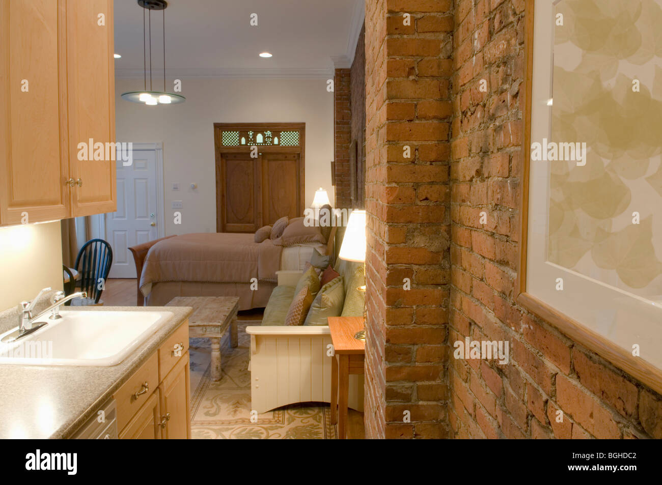 Brick wall in small studio apartment Stock Photo Alamy
