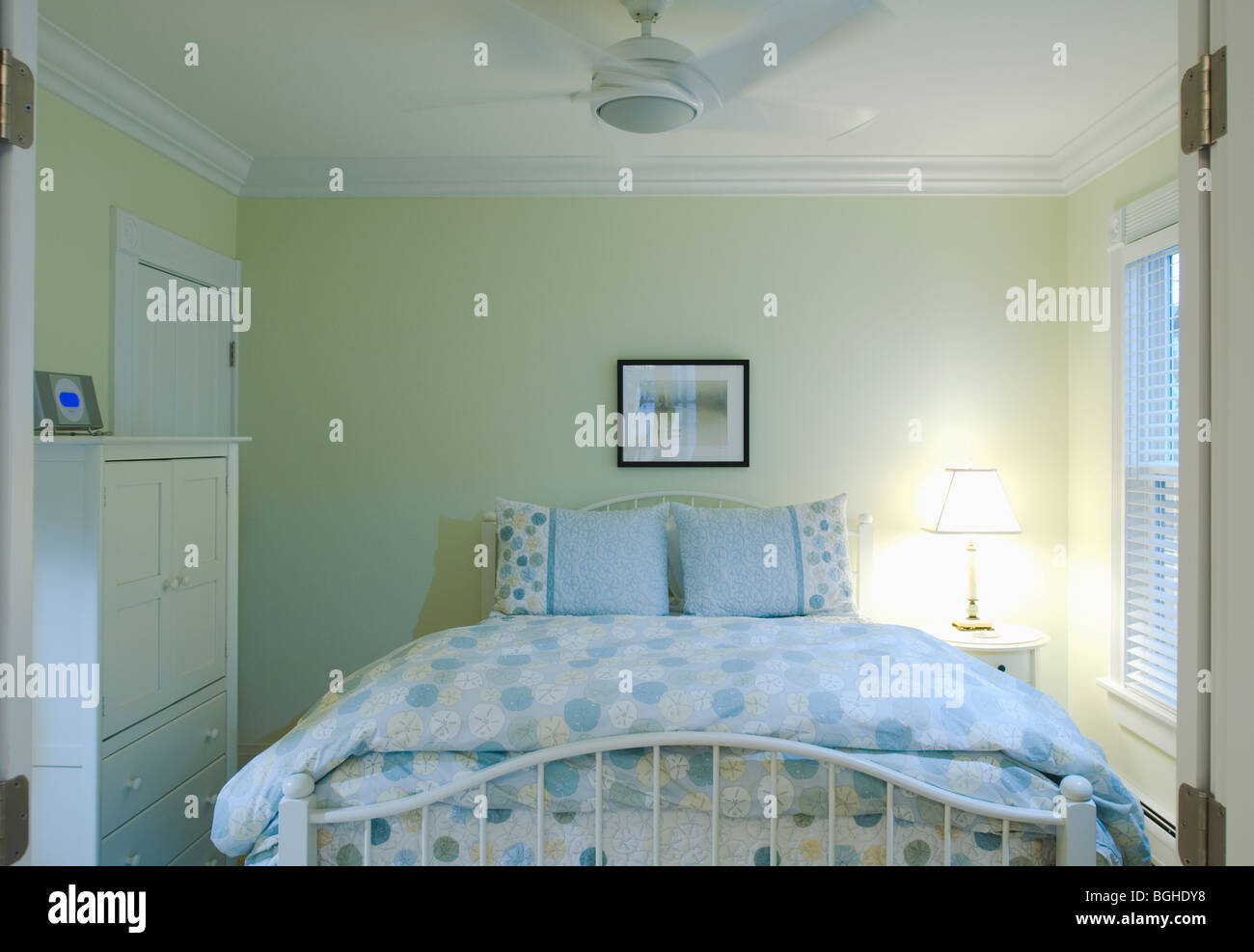 Blue and yellow bedspread on bed Stock Photo Alamy