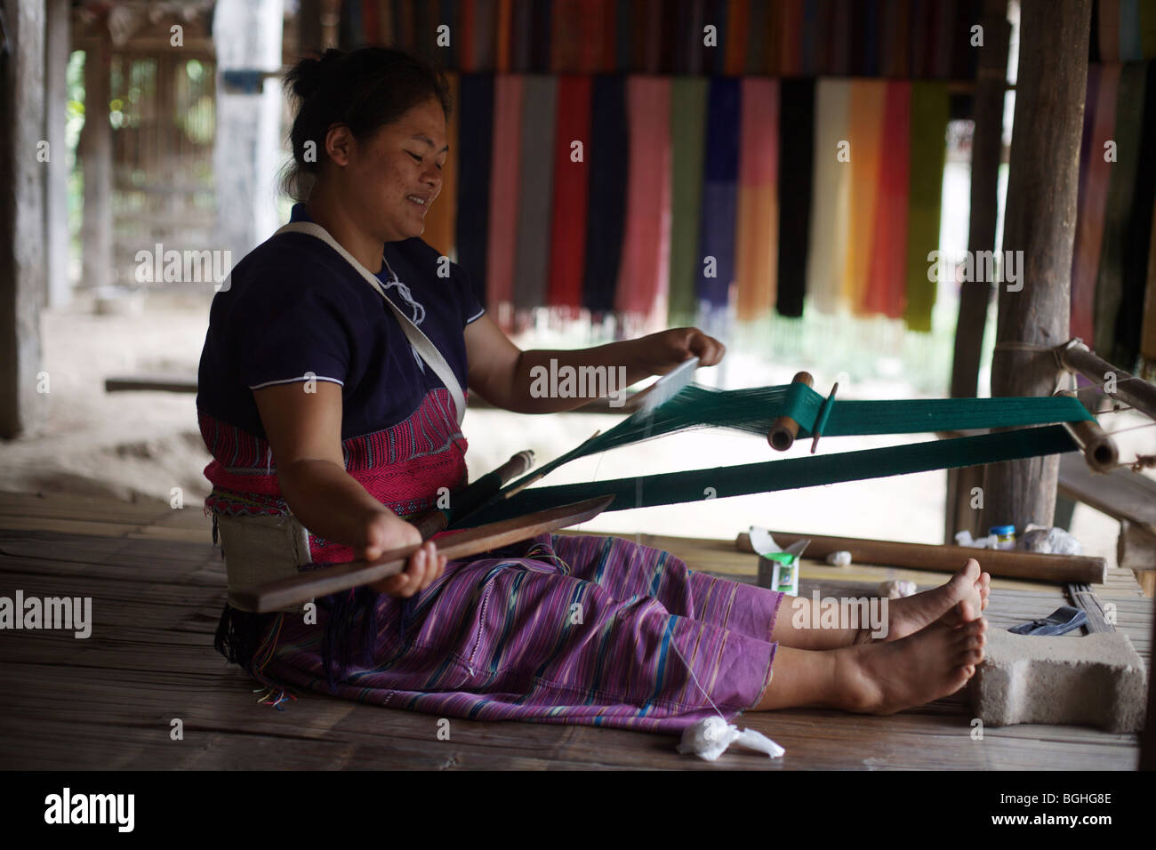 A woman from the Karen hill tribe in northern Thailand weaves textiles Stock Photo