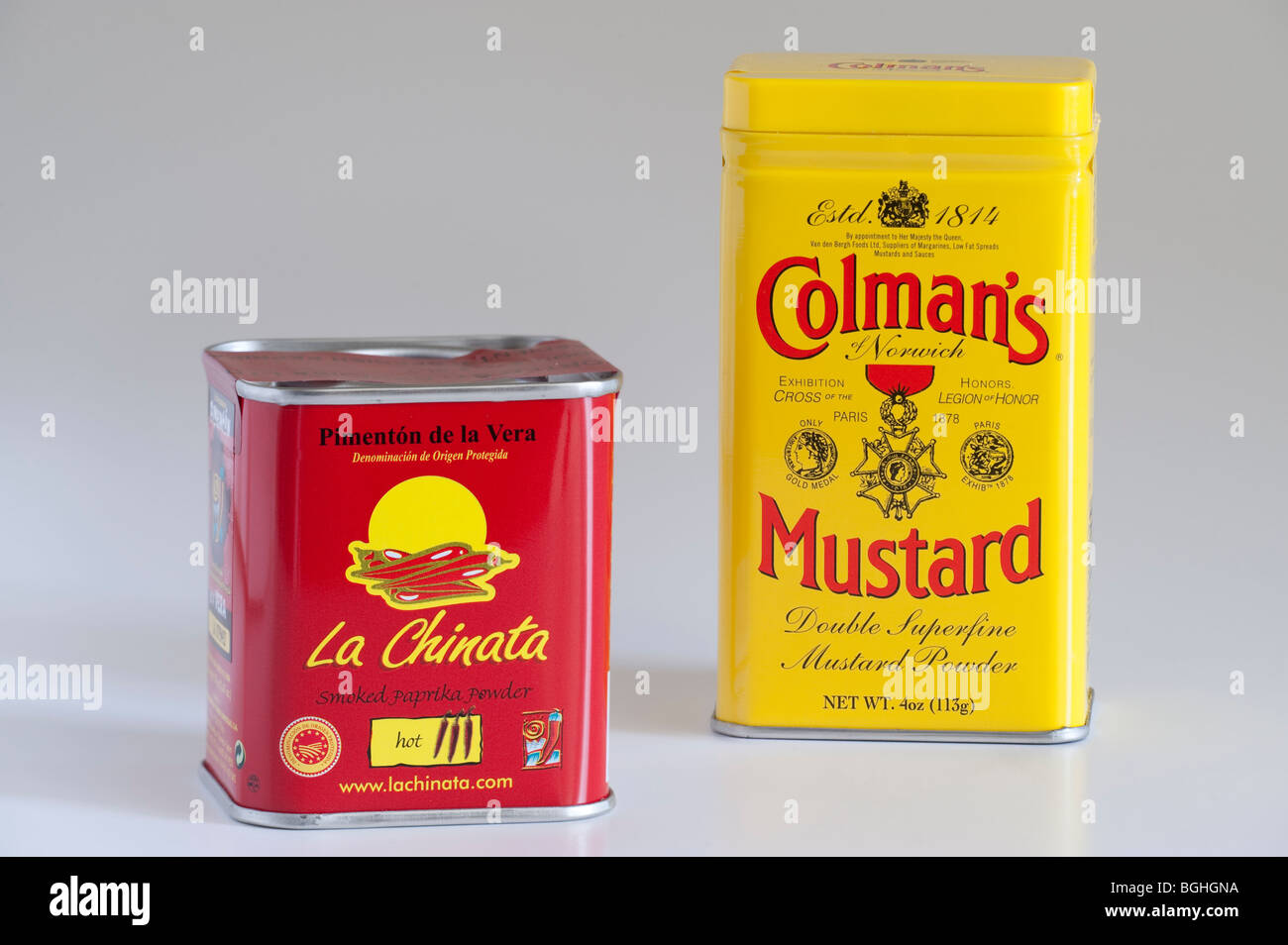 Red tin of 'Pimenton de la Vera'' La Chinata'Spanish smoked paprika powder and yellow tin of Colmans Mustard Stock Photo