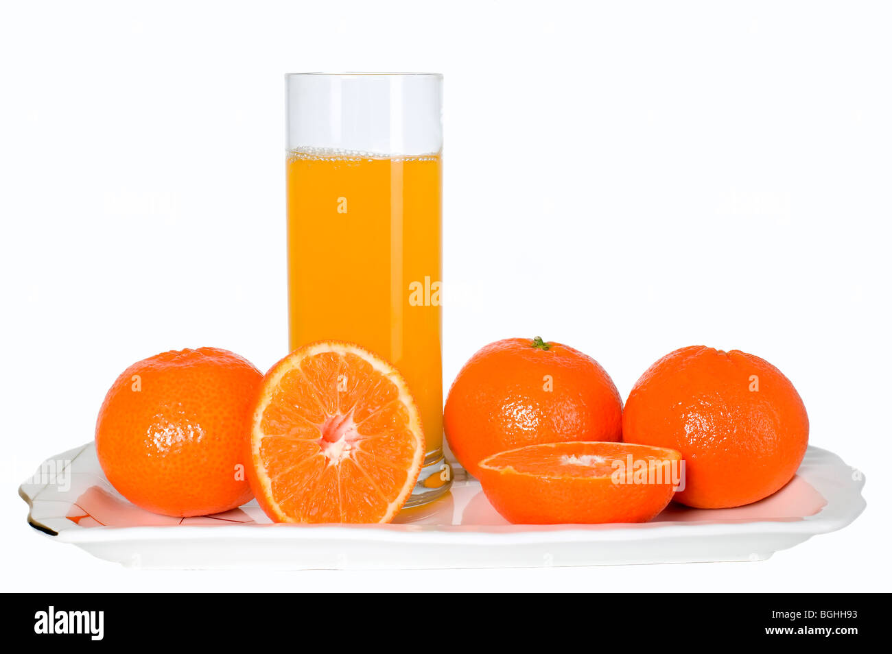 Orange fruits and glass of juice on the plate Stock Photo