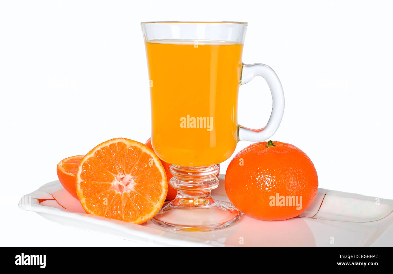 Orange fruits and glass of juice on the plate Stock Photo