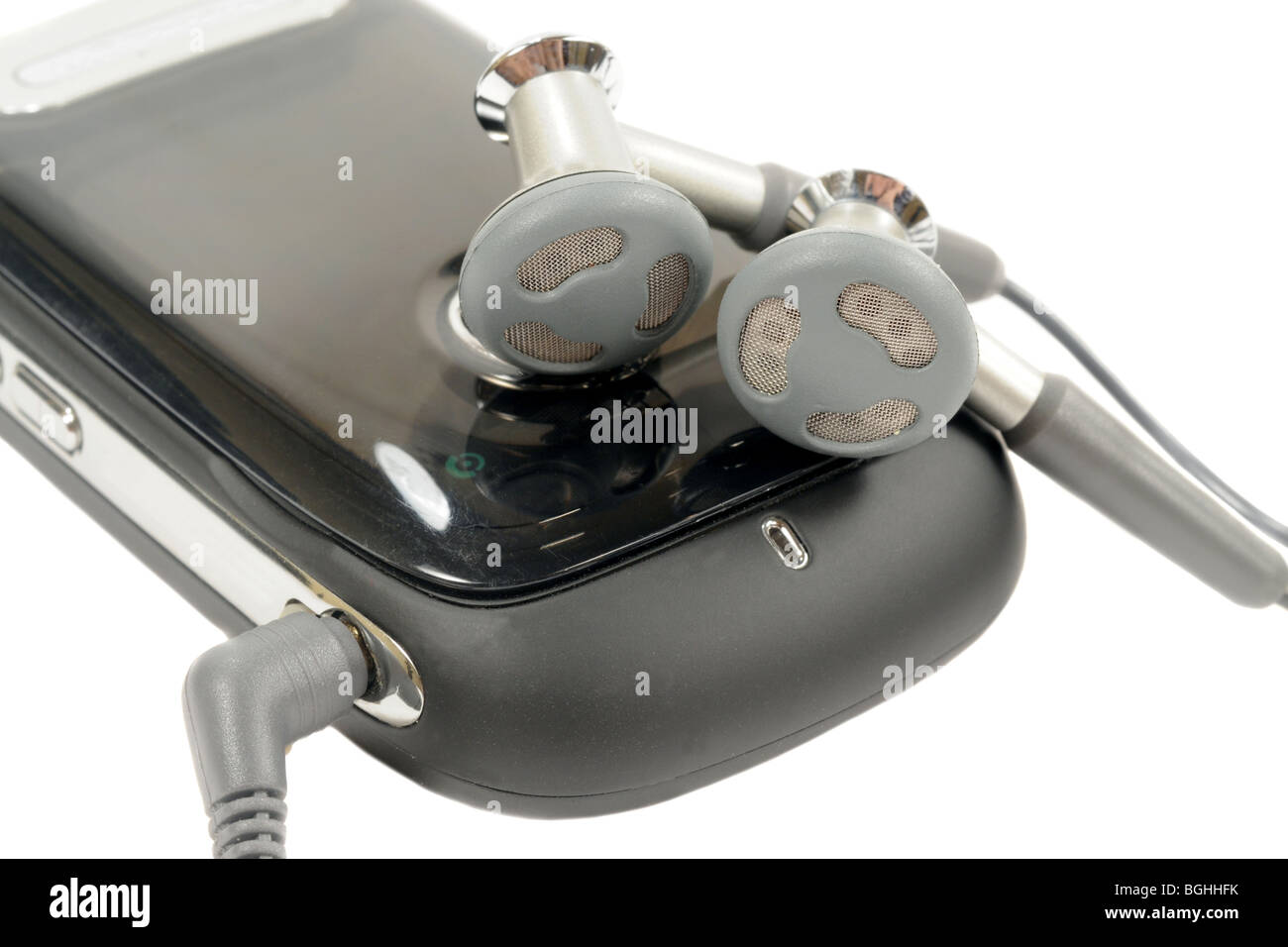 Macro shot of earphones plug into a cell phone Stock Photo